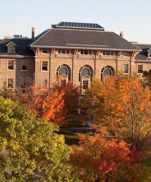 The Computing and Communications Center (CCC) behind fall trees on the Ag Quad