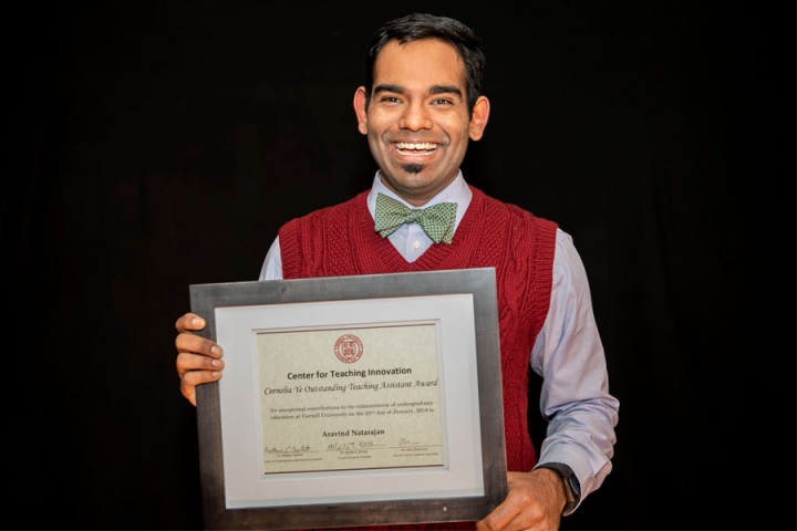 Aravind Natarajan holding his Cornelia Ye Outstanding Teaching Assistant Award