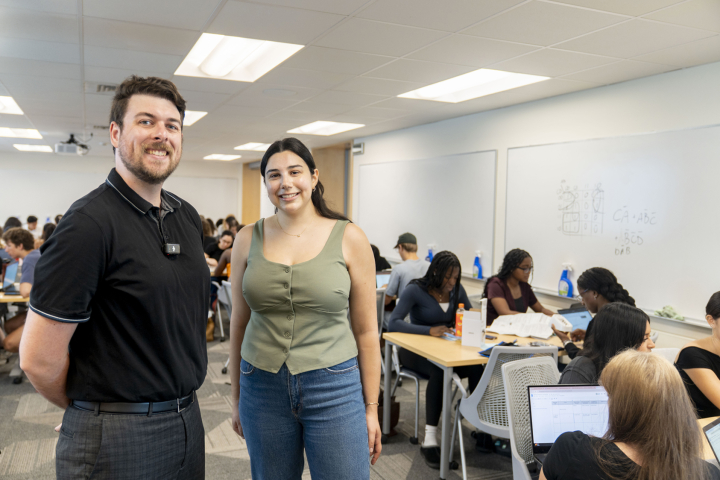Two instructors in the classroom with students working in group